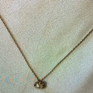 Gold necklace with acorn like shape, pearl center
